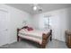 Bright secondary bedroom featuring neutral walls, a wooden bed frame, and a ceiling fan at 6993 S Sharon Ct, Chandler, AZ 85249