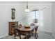 Charming dining room with an antique cabinet, decorative lighting, and large window with sheer curtains at 6993 S Sharon Ct, Chandler, AZ 85249
