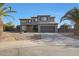 Two-story home boasts desert landscaping, a two car garage, and mature palm trees at 6993 S Sharon Ct, Chandler, AZ 85249