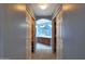 Hallway view of spacious bathroom with tub and shower behind double doors at 6993 S Sharon Ct, Chandler, AZ 85249