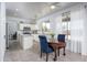 Eat-in kitchen featuring an island, white cabinetry, stainless appliances, and bright natural light at 6993 S Sharon Ct, Chandler, AZ 85249