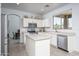 Clean kitchen features white cabinetry, stainless appliances, an island, and an open layout at 6993 S Sharon Ct, Chandler, AZ 85249