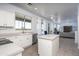 Open kitchen with an island, stainless steel appliances, white cabinets, and backyard views at 6993 S Sharon Ct, Chandler, AZ 85249