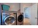 Spacious laundry room with modern washer, dryer, and folding shelf at 6993 S Sharon Ct, Chandler, AZ 85249