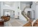 Spacious living room featuring a staircase, neutral colors, and an open layout to the dining area at 6993 S Sharon Ct, Chandler, AZ 85249