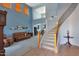 Bright living room featuring grand ceilings, a staircase with iron railing, and neutral paint at 6993 S Sharon Ct, Chandler, AZ 85249