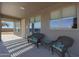 Inviting covered patio featuring wicker chairs and a side table for relaxing and enjoying the outdoors at 6993 S Sharon Ct, Chandler, AZ 85249