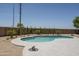 Beautiful kidney-shaped pool with a light blue tile edge and surrounding desert landscaping for outdoor pleasure at 6993 S Sharon Ct, Chandler, AZ 85249