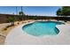 Inviting kidney-shaped pool surrounded by lush landscaping, providing a private oasis in the backyard at 6993 S Sharon Ct, Chandler, AZ 85249