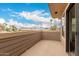 Open-air balcony with wood siding and views of palm trees and neighborhood at 702 S Beck Ave, Tempe, AZ 85281