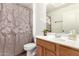 Cozy bathroom with vanity, decorative mirror, and shower with patterned curtain at 702 S Beck Ave, Tempe, AZ 85281