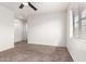 Cozy bedroom featuring neutral carpet, a ceiling fan, and double door closet at 702 S Beck Ave, Tempe, AZ 85281