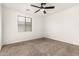 Comfortable bedroom featuring neutral carpet, ceiling fan, and sunlit window at 702 S Beck Ave, Tempe, AZ 85281