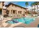 Community pool with clear blue water, surrounded by lounge chairs and palm trees for ultimate relaxation at 702 S Beck Ave, Tempe, AZ 85281