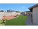 Green backyard featuring a lawn, block wall, shed, and covered patio at 7132 W Vermont Ave, Glendale, AZ 85303