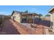 Backyard view of a covered patio with dining area and brick landscaping at 7132 W Vermont Ave, Glendale, AZ 85303