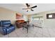 Bright living room featuring tile floors, a stylish ceiling fan, and comfortable seating arrangements at 7132 W Vermont Ave, Glendale, AZ 85303