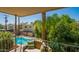 Balcony view overlooking a sparkling pool and lush tropical landscaping, offering a relaxing outdoor retreat at 7315 E Northland Dr # 8, Scottsdale, AZ 85251