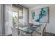 Bright dining room with glass table, modern chairs, stylish art and balcony access at 7315 E Northland Dr # 8, Scottsdale, AZ 85251