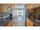 Galley kitchen with stainless steel appliances and view into the dining room at 7315 E Northland Dr # 8, Scottsdale, AZ 85251