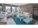 Bright living room featuring white furniture, a brick accent wall, and a large window with views at 7315 E Northland Dr # 8, Scottsdale, AZ 85251