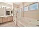 Bathroom with shower, soaking tub, dual sink vanity, and natural light at 7401 W Arrowhead Clubhouse Dr # 2012, Glendale, AZ 85308