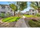 Beautifully landscaped grounds with a winding walkway and lush greenery between buildings at 7401 W Arrowhead Clubhouse Dr # 2012, Glendale, AZ 85308