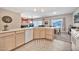 This kitchen includes an island with sink, wooden cabinets, and tile flooring at 7401 W Arrowhead Clubhouse Dr # 2012, Glendale, AZ 85308