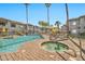 Community pool featuring a relaxing hot tub and plenty of lounge seating amidst palm trees and clear skies at 7401 W Arrowhead Clubhouse Dr # 2012, Glendale, AZ 85308