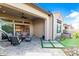 This covered patio has an outdoor fireplace, seating, a grill and a putting green at 7518 E Vista Bonita Dr, Scottsdale, AZ 85255