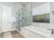 This bathroom features a glass enclosed shower, tub, and bright window at 7518 E Vista Bonita Dr, Scottsdale, AZ 85255