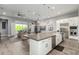 Modern kitchen featuring a large island with seating, stainless steel appliances and a view to the living area at 7518 E Vista Bonita Dr, Scottsdale, AZ 85255