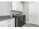 The well-organized laundry room features modern appliances, counter space, and ample cabinet storage at 7518 E Vista Bonita Dr, Scottsdale, AZ 85255