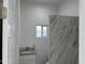 Modern bathroom with marble tiled walls, granite countertop sink, and white fixtures, offering a spa-like experience at 824 S 3Rd Ave, Phoenix, AZ 85003