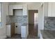 Kitchen featuring white cabinets and modern backsplash, awaiting appliances for a sleek and functional cooking space at 824 S 3Rd Ave, Phoenix, AZ 85003