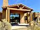 Inviting covered back patio featuring wood beams, neutral colors, and a spiral staircase leading to the upper level at 8386 E Arroyo Seco Rd, Scottsdale, AZ 85266