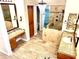 Modern bathroom with dual vanities, granite counters, tiled shower, and chandelier at 8386 E Arroyo Seco Rd, Scottsdale, AZ 85266