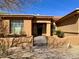 Charming home with an inviting entrance, decorative windows, and manicured desert landscaping at 8386 E Arroyo Seco Rd, Scottsdale, AZ 85266