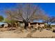 Well maintained home with desert landscaping and mature trees on a clear, sunny day at 8386 E Arroyo Seco Rd, Scottsdale, AZ 85266