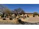 Charming, single-story home featuring desert landscaping and a private driveway on a sunny day at 8386 E Arroyo Seco Rd, Scottsdale, AZ 85266