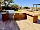 Well-equipped outdoor kitchen with stainless steel grill, prep space, and bar seating, perfect for entertaining at 8386 E Arroyo Seco Rd, Scottsdale, AZ 85266