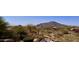 Resort style pool with a rock waterfall feature overlooking a scenic mountain view at 8386 E Arroyo Seco Rd, Scottsdale, AZ 85266