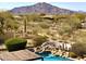 Resort style pool with a rock waterfall feature overlooking a scenic mountain view at 8386 E Arroyo Seco Rd, Scottsdale, AZ 85266