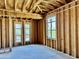 A room is under construction with wood studs and two windows offering a view of the mountains at 8386 E Arroyo Seco Rd, Scottsdale, AZ 85266