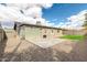 A spacious backyard featuring a concrete patio, gravel, and a patch of green grass at 8637 E Jackrabbit Rd, Scottsdale, AZ 85250