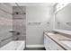 Bathroom with a shower/tub combo and a double sink vanity with light stone countertop at 8637 E Jackrabbit Rd, Scottsdale, AZ 85250