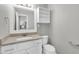 Updated bathroom featuring a granite countertop, white cabinets, and modern fixtures at 8637 E Jackrabbit Rd, Scottsdale, AZ 85250