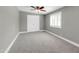 Bright bedroom with neutral walls and carpet, ceiling fan and window with white shutters at 8637 E Jackrabbit Rd, Scottsdale, AZ 85250