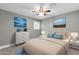 Bright primary bedroom featuring neutral walls and décor, ceiling fan, and bright window at 8637 E Jackrabbit Rd, Scottsdale, AZ 85250