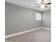 Light and bright bedroom with neutral gray walls and carpet, ceiling fan, and window with shutters at 8637 E Jackrabbit Rd, Scottsdale, AZ 85250